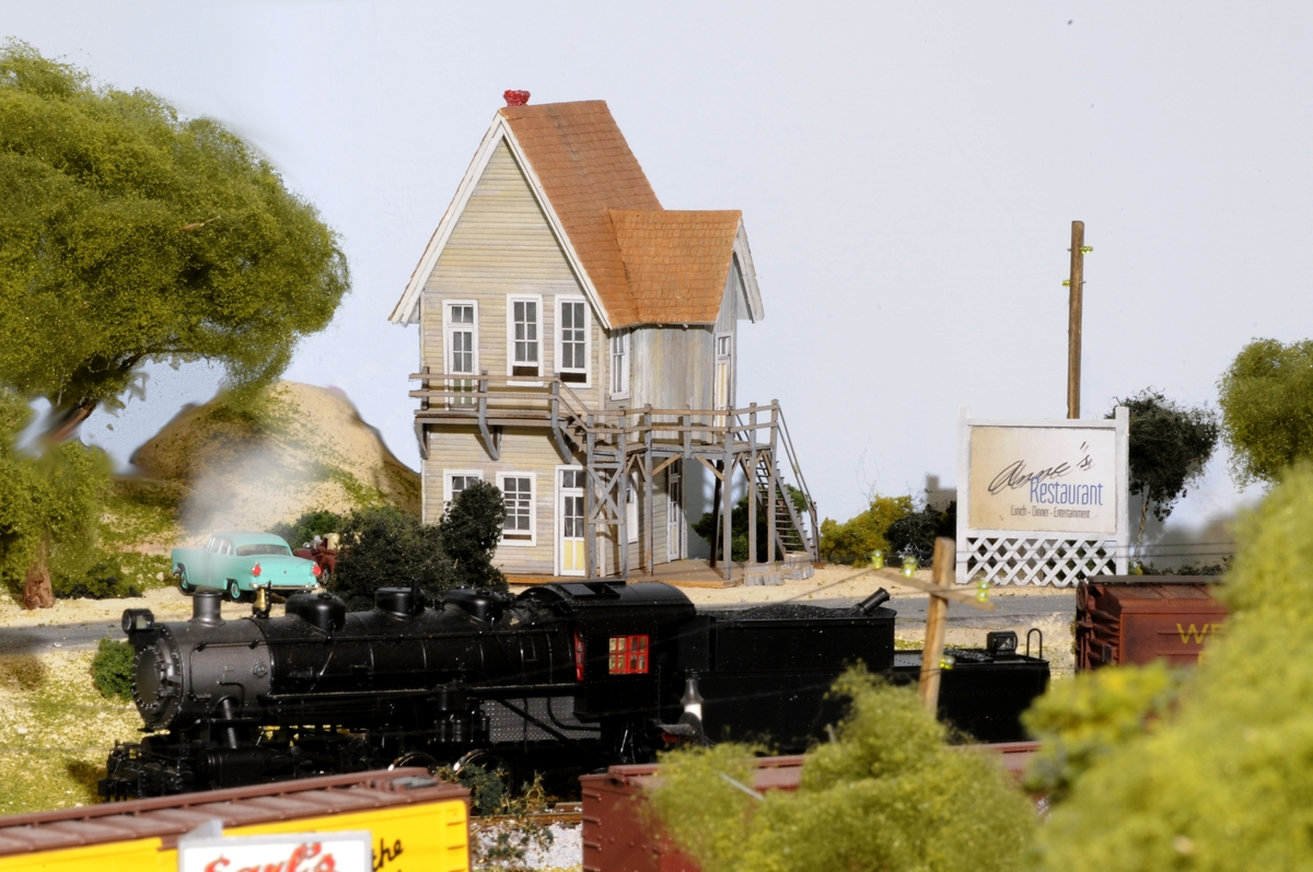 Our do-anything 0-8-0 Switcher with a short string of boxcars begins a pass by Anne's Restaurant